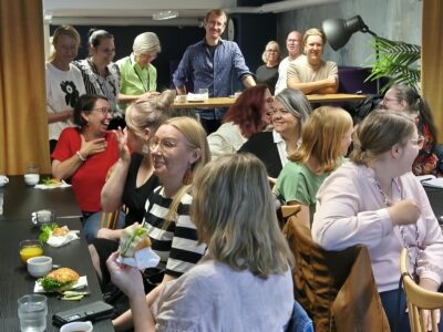 Ihmiset keskustelevat Täsmänän verkostotapaamisessa.